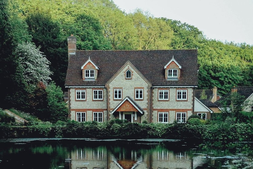 a large beautiful home overlooking a lake