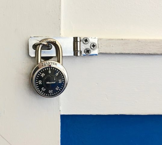 A combination lock keeping a door closed