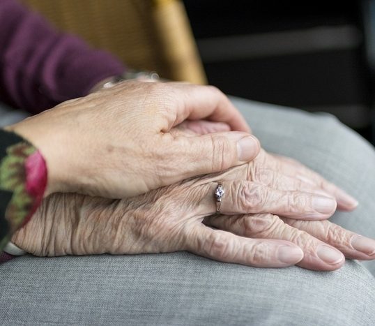 person holding an elderly person's hand