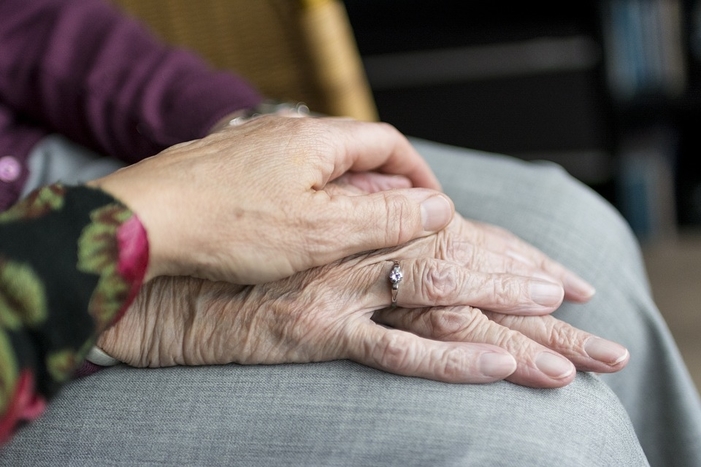 person holding an elderly person's hand