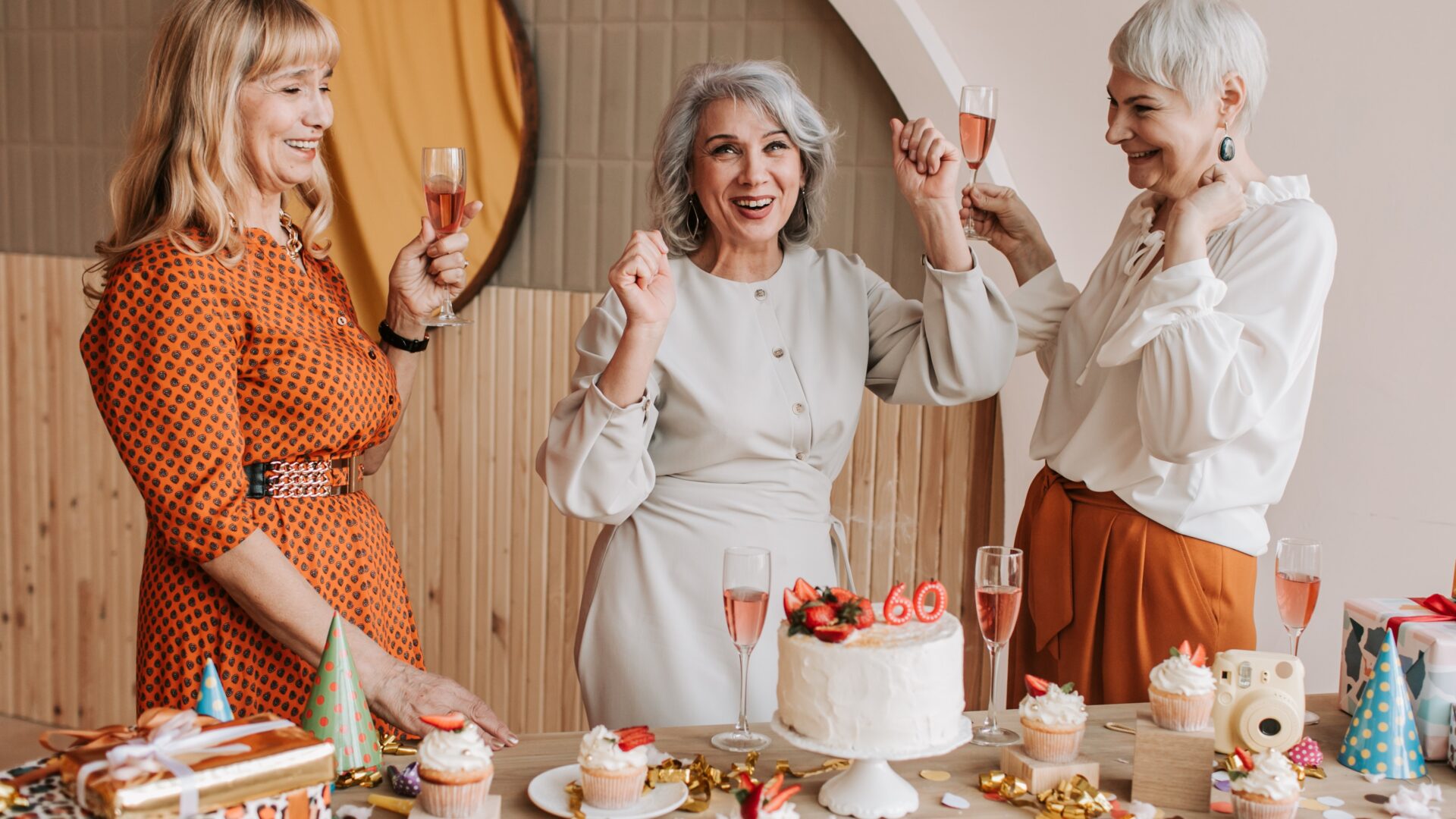 showing normal-minimum-pension-age. Three retired women celebrating their 60th birthday
