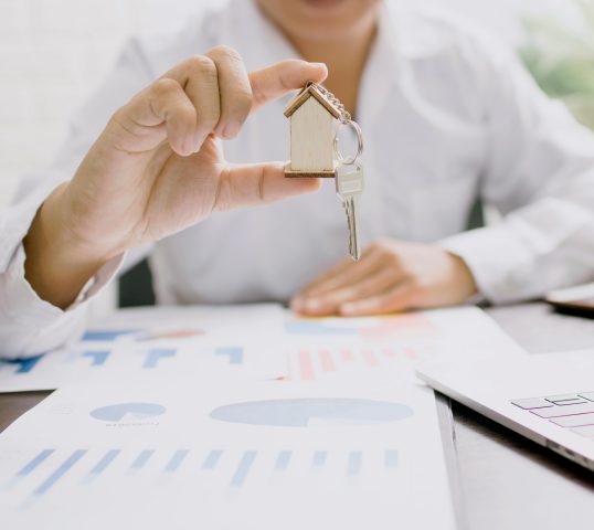 Man holding house ornament.